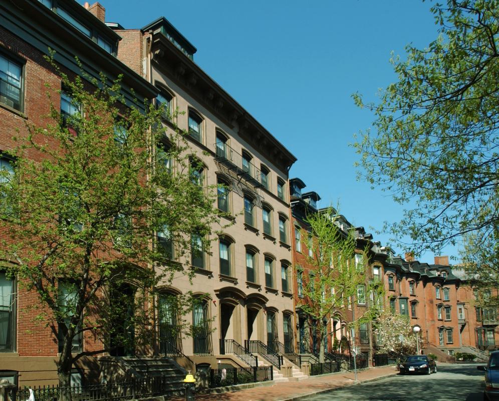 Row of building façades along curving street