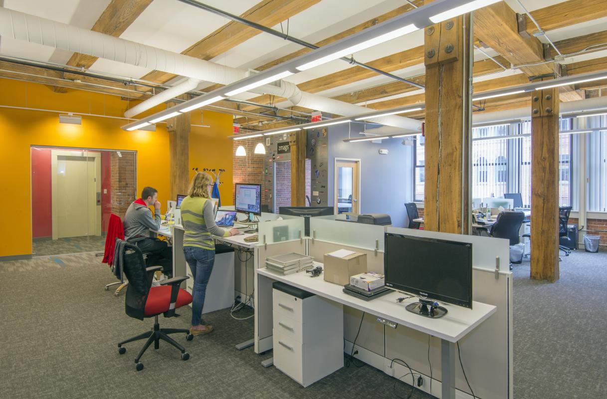 Open office area with exposed heavy-timber posts and beams