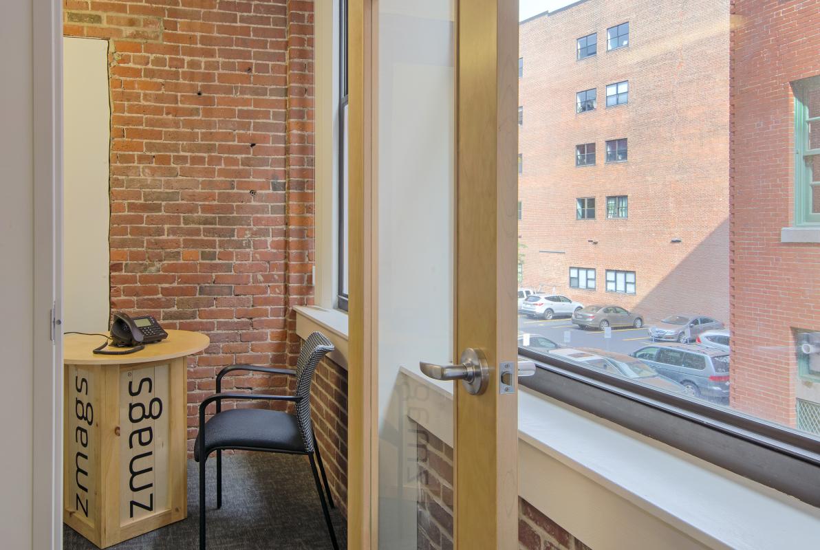 Conference room detail with windows and exposed brick walls