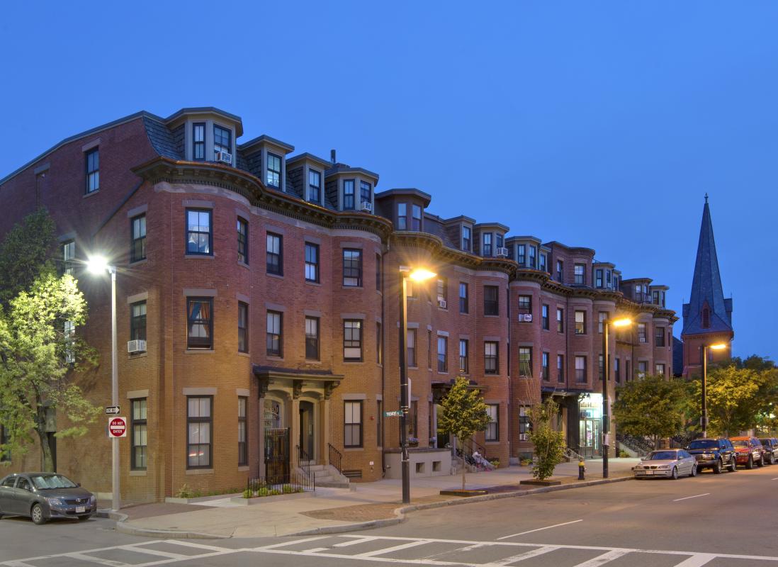 Row of buildings from street corner at twilight