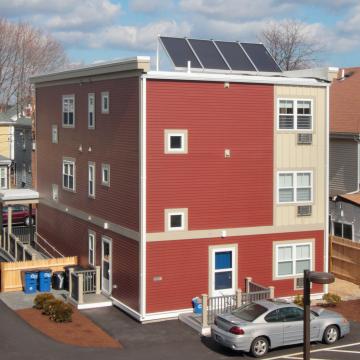 Elevated view of rear corner exterior with roof solar panels