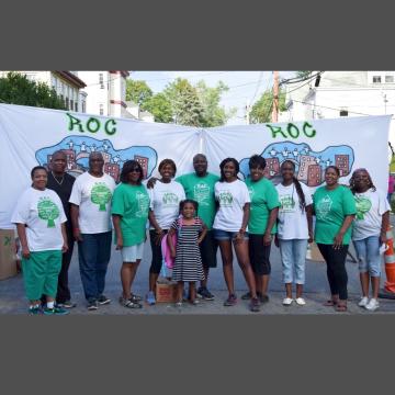 Redefining Our Community (ROC) members standing in front of ROC banners.